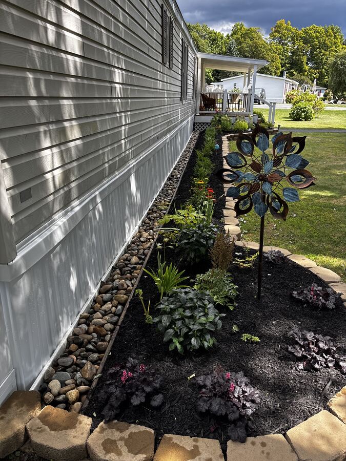 Finished river rock border with planting bed